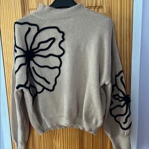 Elegant Beige Sweater with Black Floral Design